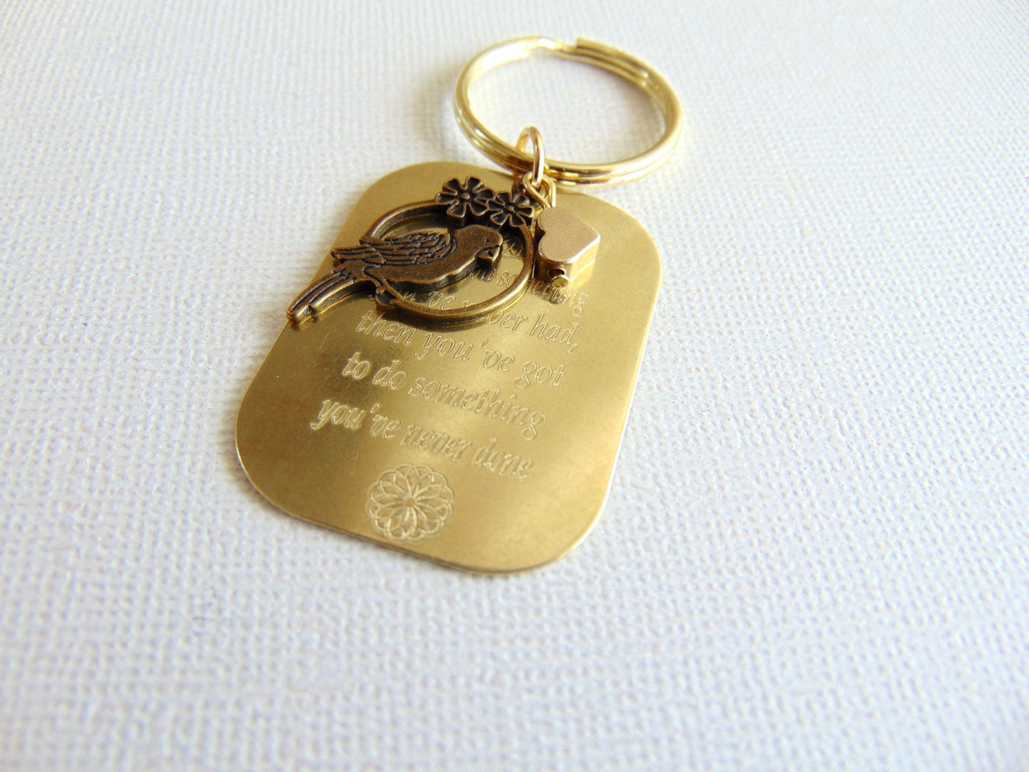 Personalized message engraved on keychain, in gold (Brass)