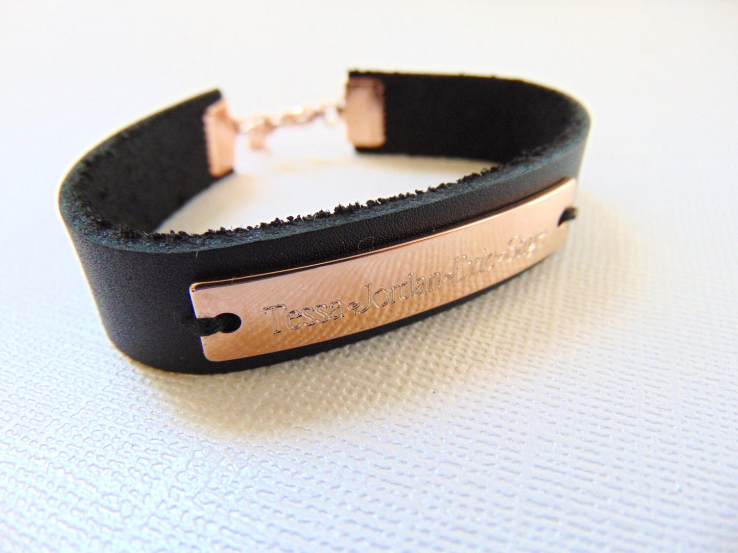 Customized engraving on rose gold cuff bracelet with black/brown leather