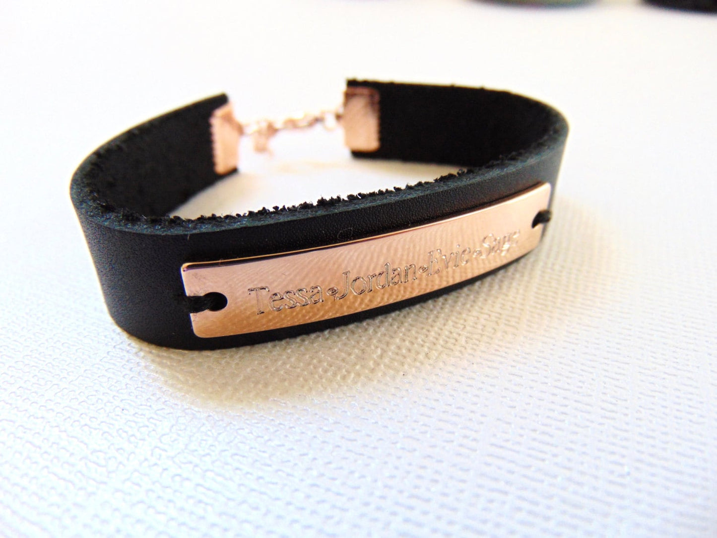 Customized engraving on rose gold cuff bracelet with black/brown leather